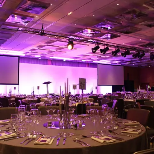 A corporate events setting with well-dressed professionals, showcasing an atmosphere of professionalism and refinement.