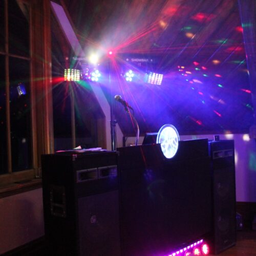 Mobile DJ setup with colorful lights at a bar, ready to set the stage for an unforgettable night of music and entertainment.