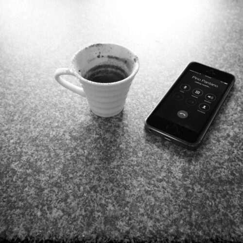 Coffee and Mobile Phone for DJ Hire Inquiry.
